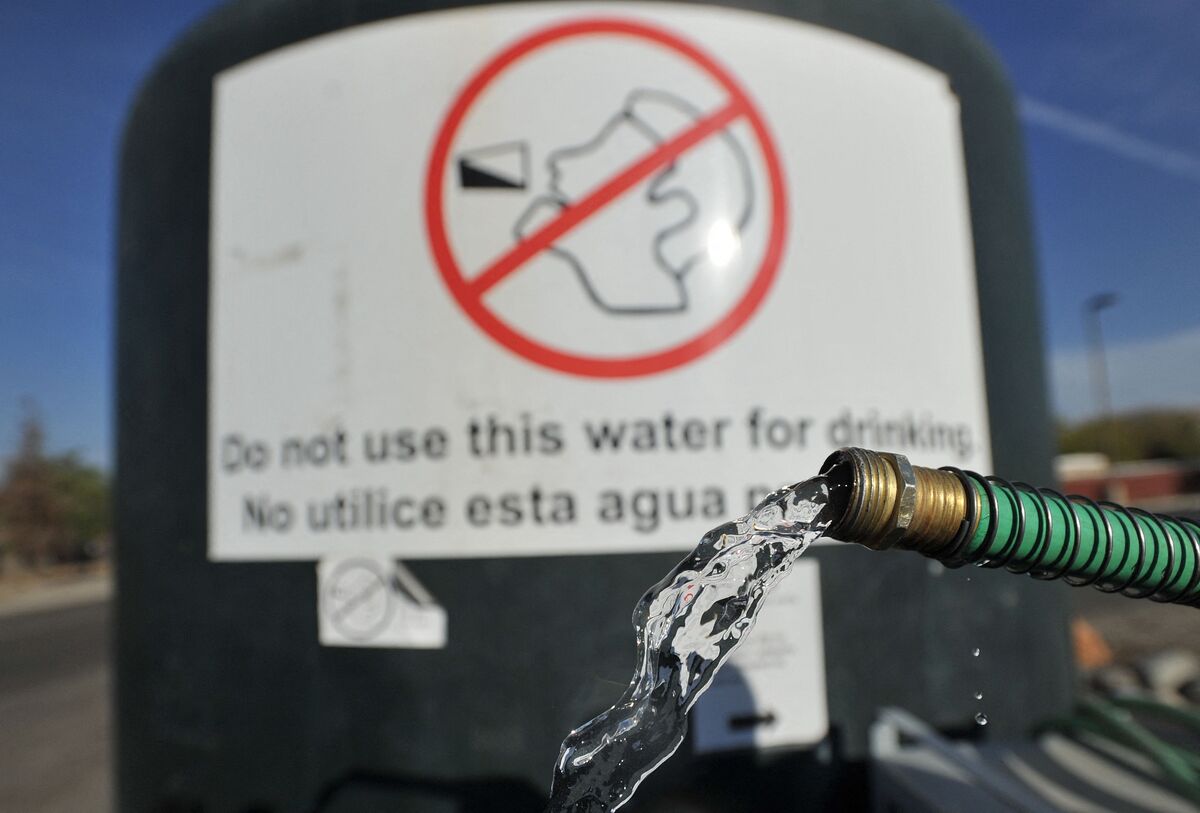  A hose spouts water from a non-potable tank in front of the Doyle Colony Fire Station in Porterville, California, on September 21, 2015. 