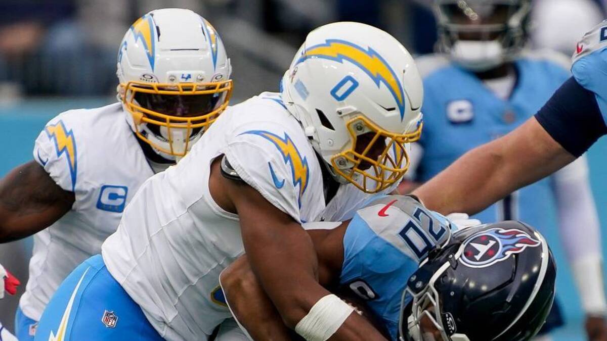  Tennessee Titans running back Tony Pollard (20) is stopped by Los Angeles Chargers linebacker Daiyan Henley (0) and safety RJ Mickens (27) during the first quarter at Nissan Stadium in Nashville, Tenn., Sunday, Nov. 2, 2025. | Andrew Nelles / The Tennessean / USA TODAY NETWORK via Imagn Images 
