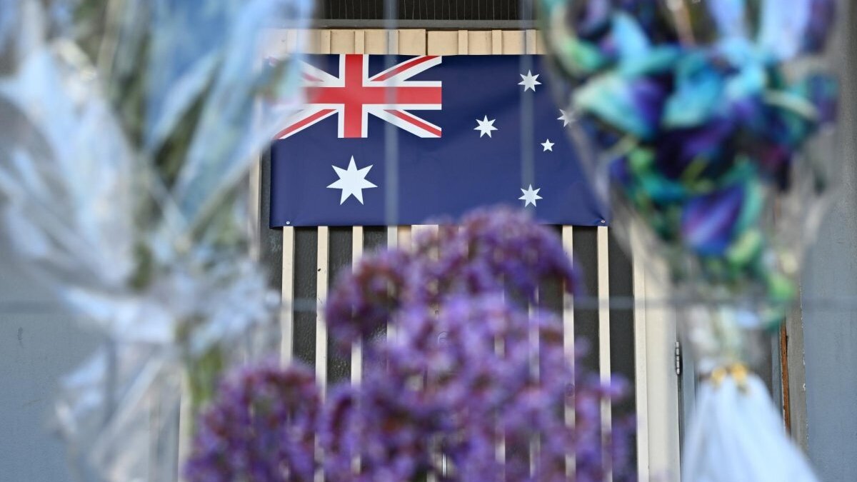 People leave flowers and an Australian flag at a tribute at the Adass Israel Synagogue after a arson attack in Melbourne, Australia, in December 2024. A third suspected arsonist was arrested Friday. File Photo by Joel Carrett/EPA