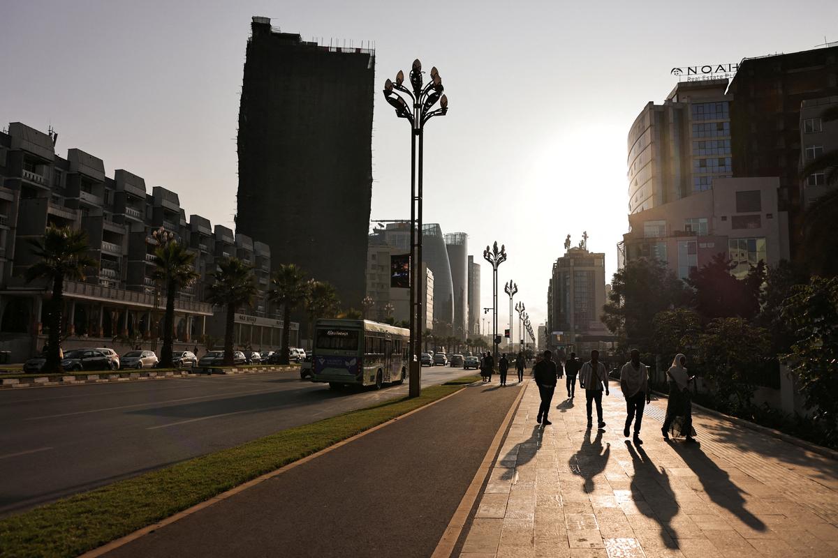 FILE PHOTO: Pedestrians walk along Bole Road in Addis Ababa, Ethiopia, December 19, 2025. REUTERS/Tiksa Negeri/File Photo