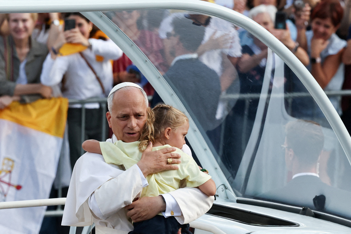 Pope Leo XIV hugs a child as he arrives to attend a prayer vigil at the Lluis Companys Olympic Stadium, during his apostolic journey, in Barcelona, Spain, June 9, 2026. REUTERS/Yara Nardi