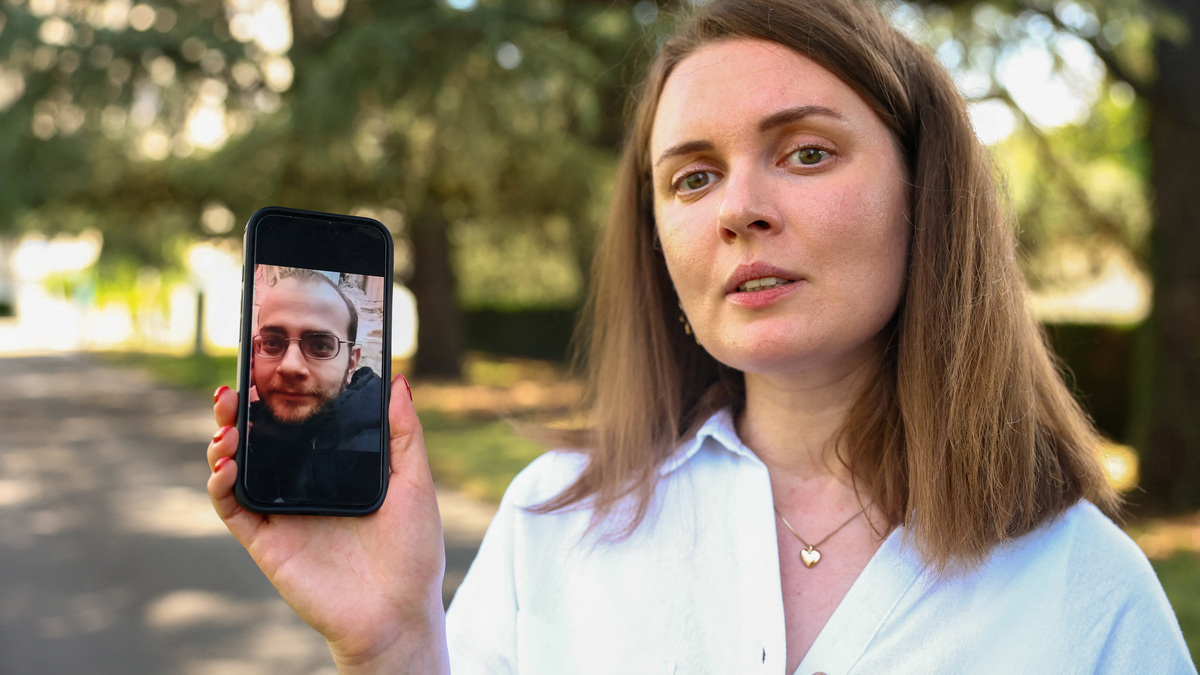 Belarussian journalist Katsyaryna Andreyeva shows a picture of her husband Ihar Ilyash on her mobile device after an interview with Reuters at the United Nations in Geneva, Switzerland, June 29, 2026. REUTERS/Denis Balibouse