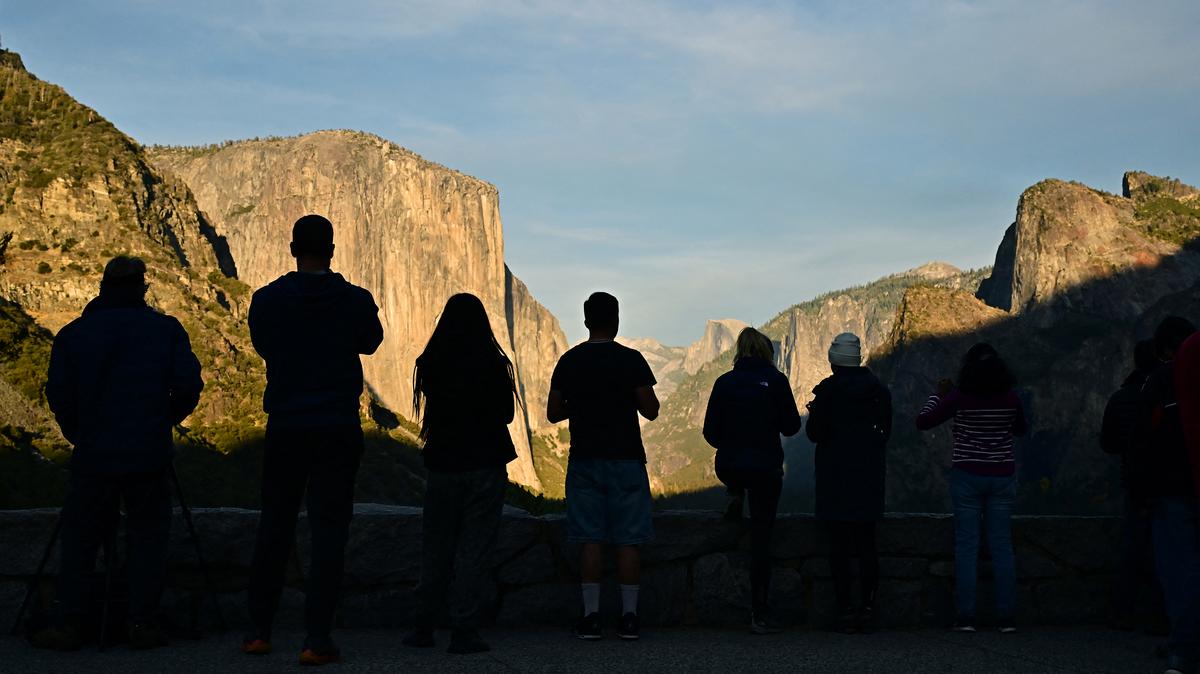 Visitors look out over Yosemite Valley from Tunnel View lookout point, with the famed granite formations El Capitan (L) and Half Dome (C) in view, at Yosemite National Park on Oct. 24, 2025, amid the ongoing US government shutdown. Thousands of adrenaline junkies including BASE jumpers are flocking to California's Yosemite National Park, as the US government shutdown leaves park rangers short-staffed to cope at the world-renowned climbing destination. The shutdown, which began on October 1 due to the budget impasse between Republicans and Democrats in Congress, has seen personnel levels plummet at this national park -- which is home to the imposing 3,000-foot granite wall known as El Capitan. "We're challenged," a park ranger told AFP, on condition of anonymity.
"A lot of rangers have been furloughed" and those still working have had to contend with "an increase in illegal activity," he said. (Frederic J. Brown/AFP/Getty Images/TNS)