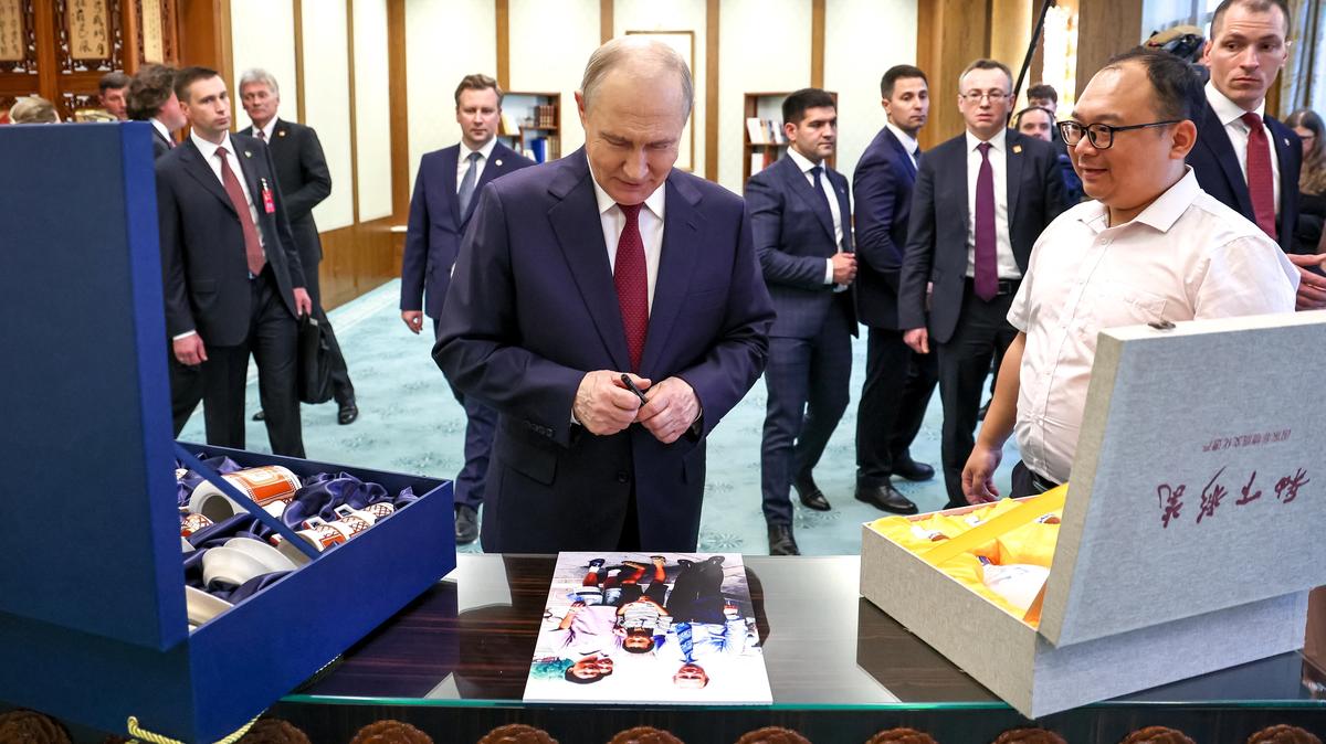 Russian President Vladimir Putin meets with Chinese engineer Peng Pai, who was photographed with him as a child 25 years ago during his first visit to China, at the Great Hall of the People in Beijing, China May 20, 2026. Sputnik/Alexander Kazakov/Pool via REUTERS
