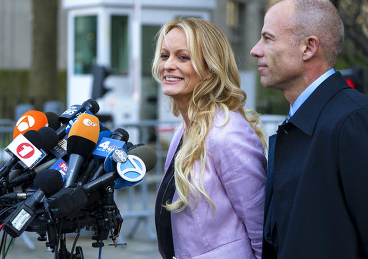 Adult film actress Stormy Daniels speaks to members of the media after a hearing at federal court, Monday, April 16, 2018, in New York, as she is accompanied by her attorney Michael Avenatti.