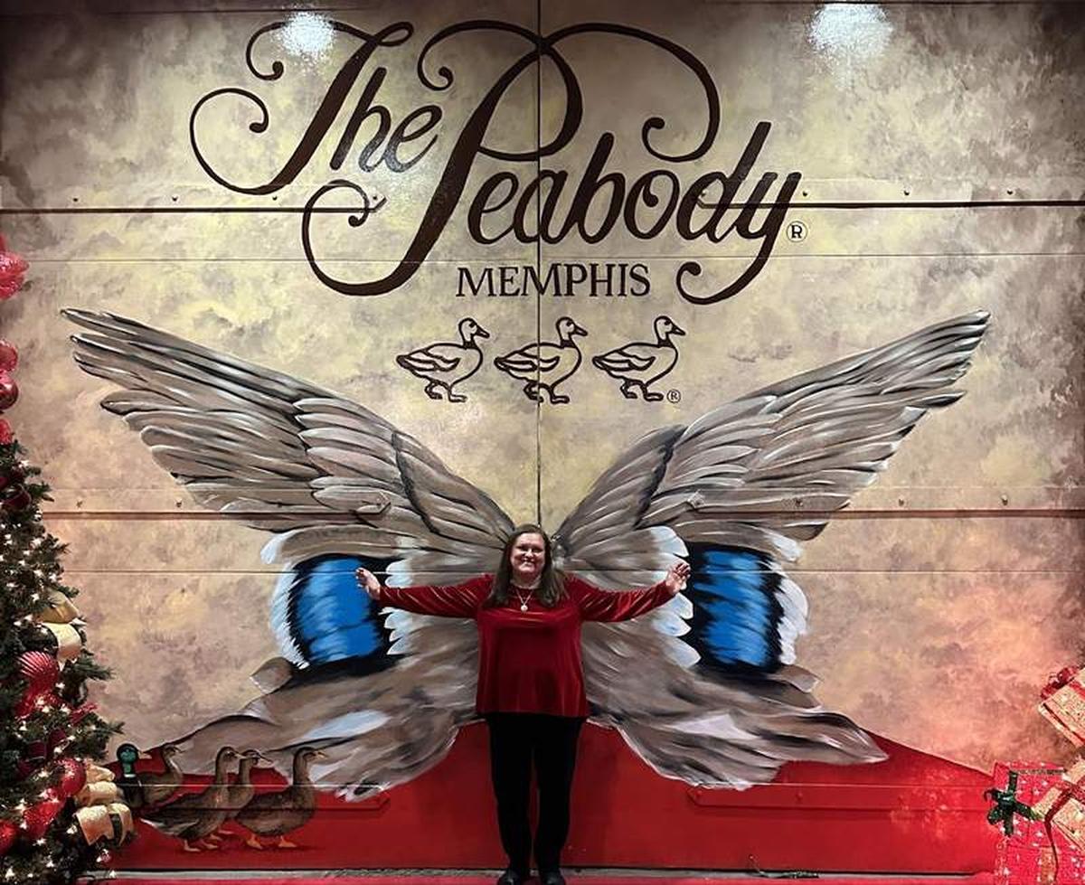  The author standing in front of the wing mural at the Peabody Hotel. Photo credit: Robin O’Neal Smith 