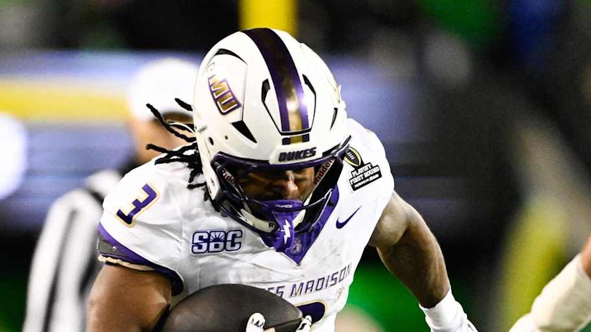  Dec 20, 2025; Eugene, OR, USA; James Madison Dukes running back Wayne Knight (3) rushes as Oregon Ducks defensive back Aaron Flowers (21) defends during the second quarter at Autzen Stadium. Mandatory Credit: Troy Wayrynen-Imagn Images | Troy Wayrynen-Imagn Images 