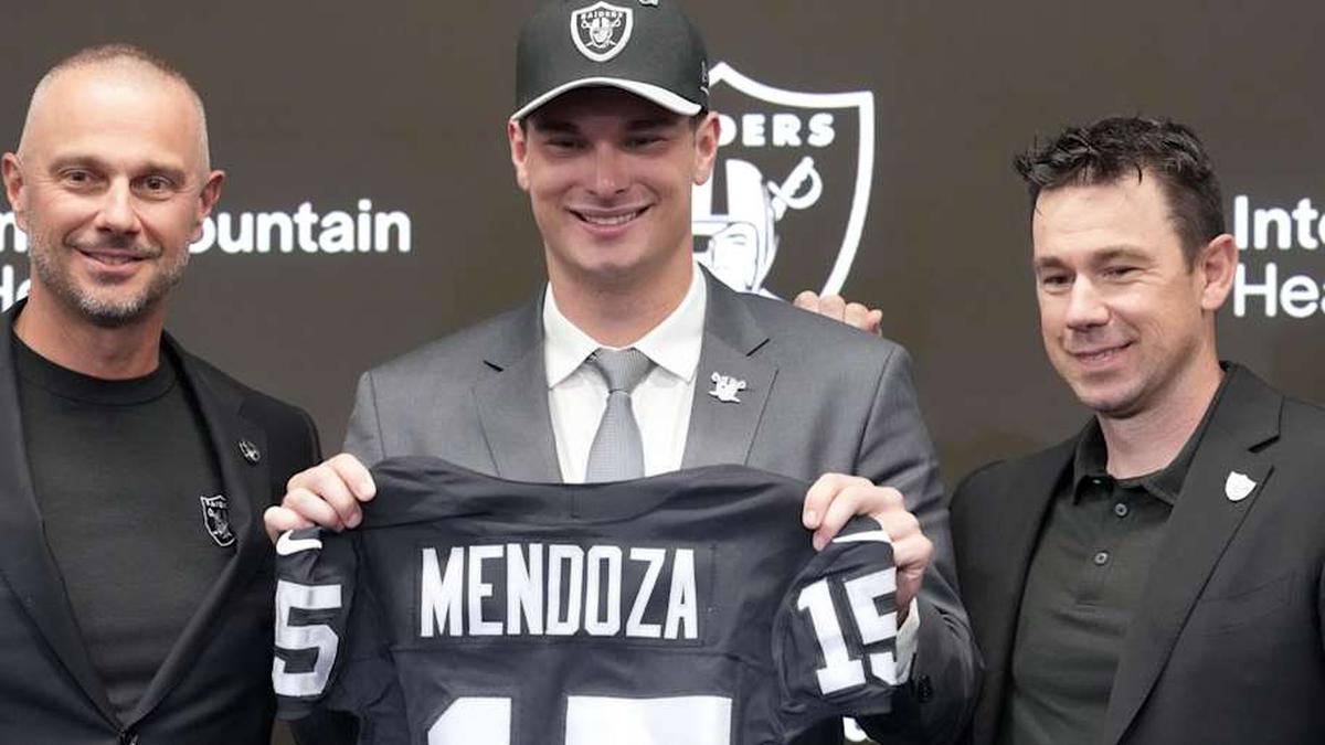 Apr 24, 2026; Henderson, NV, USA; Las Vegas Raiders quarterback Fernando Mendoza (center) poses with general manager John Spytek (left) and head coach Klint Kubiak at introductory press conference at Intermountain Health Performance Center after being selected as the No. 1 pick in the 2026 NFL Draft. Mandatory Credit: Kirby Lee-Imagn Images | Kirby Lee-Imagn Images 