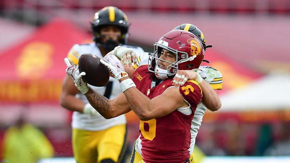  Nov 15, 2025; Los Angeles, California, USA; Southern California Trojans wide receiver Makai Lemon (6) catches a pass against the defense of Iowa Hawkeyes defensive back Zach Lutmer (6) during the second half at the Los Angeles Memorial Coliseum. Mandatory Credit: Gary A. Vasquez-Imagn Images | Gary A. Vasquez-Imagn Images 