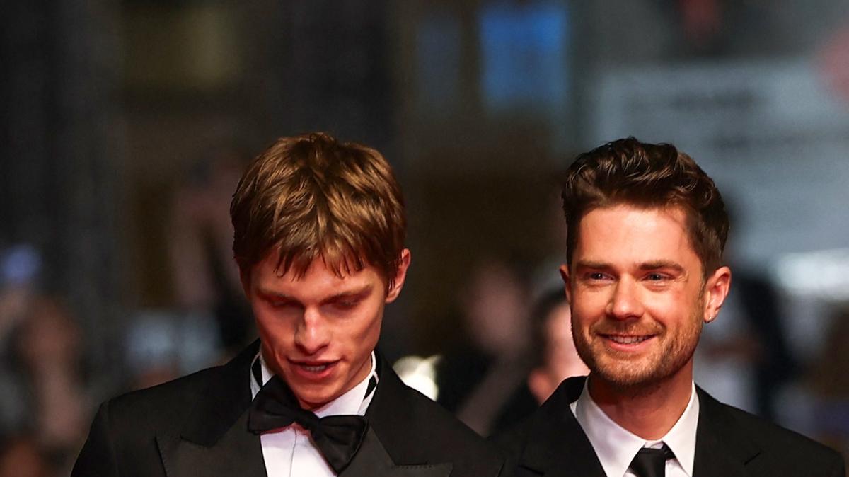 Director Lukas Dhont, cast members Emmanuel Macchia and Valentin Champagne pose on the red carpet during arrivals for the screening of the film "Coward" in competition at the 79th Cannes Film Festival in Cannes, France, May 21, 2026. REUTERS/Gonzalo Fuentes
