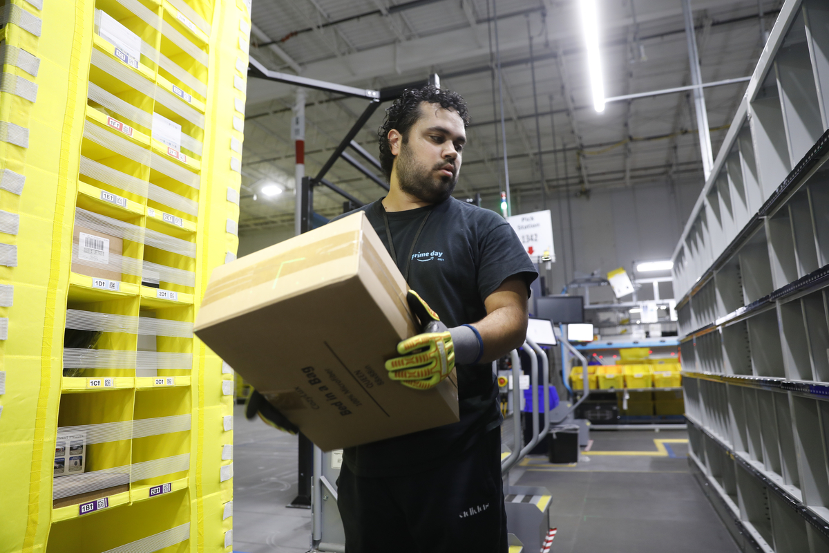  TAMPA, FLORIDA – NOVEMBER 27: Amazon associate Luis Colon works to ship out same day orders during Cyber Monday at the Same-Day Delivery Facility Fulfillment Center on November 27, 2023 in Tampa, Florida. Dedicated to online shopping, Cyber Monday is one of Amazon’s busiest days following Thanksgiving, marked by retailers providing substantial discounts and promotions. 