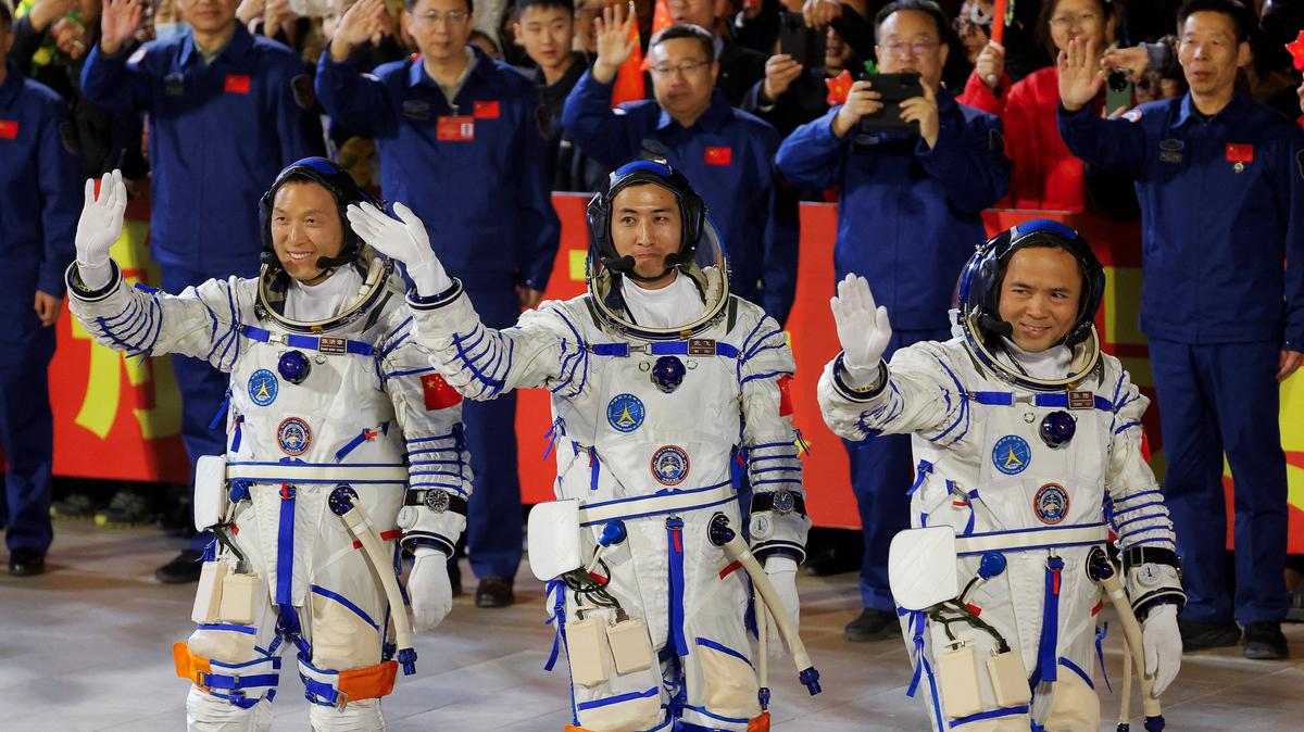 Astronauts Zhang Hongzhang, Wu Fei, and Zhang Lu wave during a see-off ceremony before taking part in the Shenzhou-21 spaceflight mission to China's Tiangong space station, at  Jiuquan Satellite Launch Center, near Jiuquan, Gansu province, China October 31, 2025. REUTERS/Maxim Shemetov