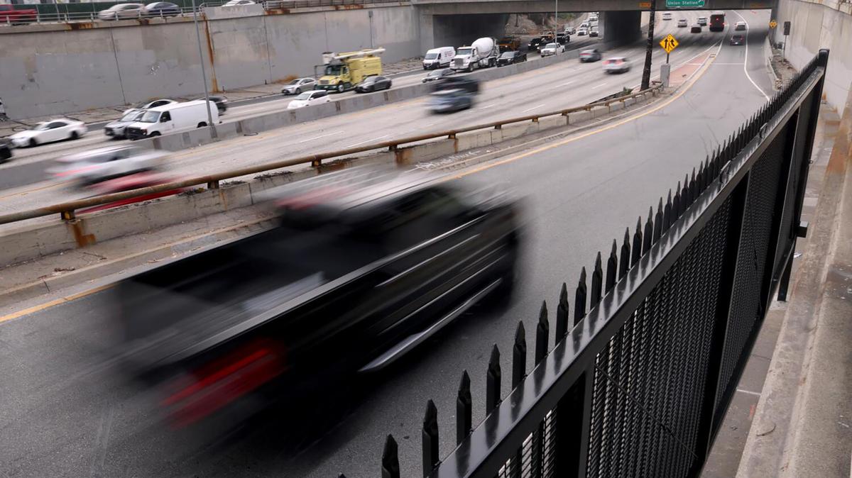 A truck travels down an onramp toward the freeway.