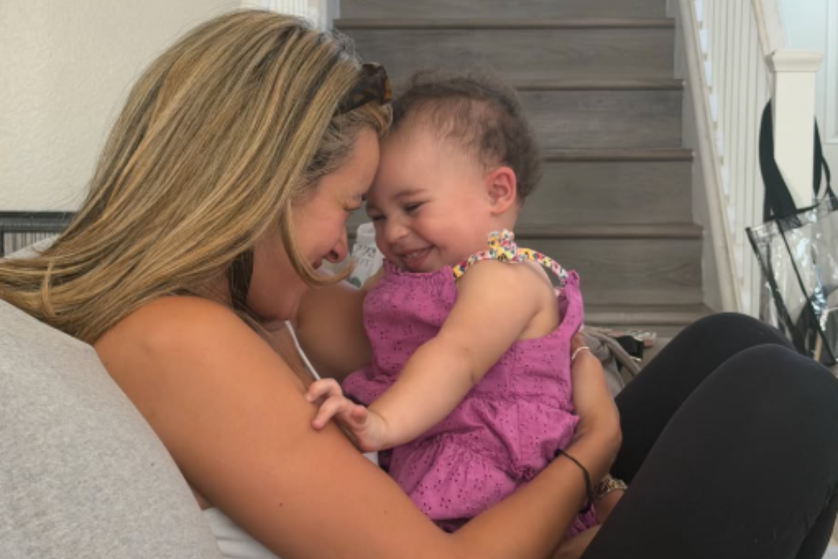  Lycette Beatty cuddles her granddaughter Khloe Rae on a couch at home. 