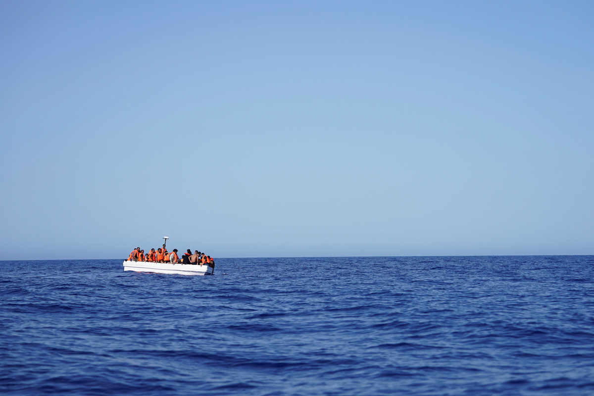 Migrants on a fiberglass boat wait to be assisted by NGO Open Arms rescue boat "Astral" in international waters south of Lampedusa, in the Mediterranean Sea, July 24, 2025. REUTERS/Ana Beltran