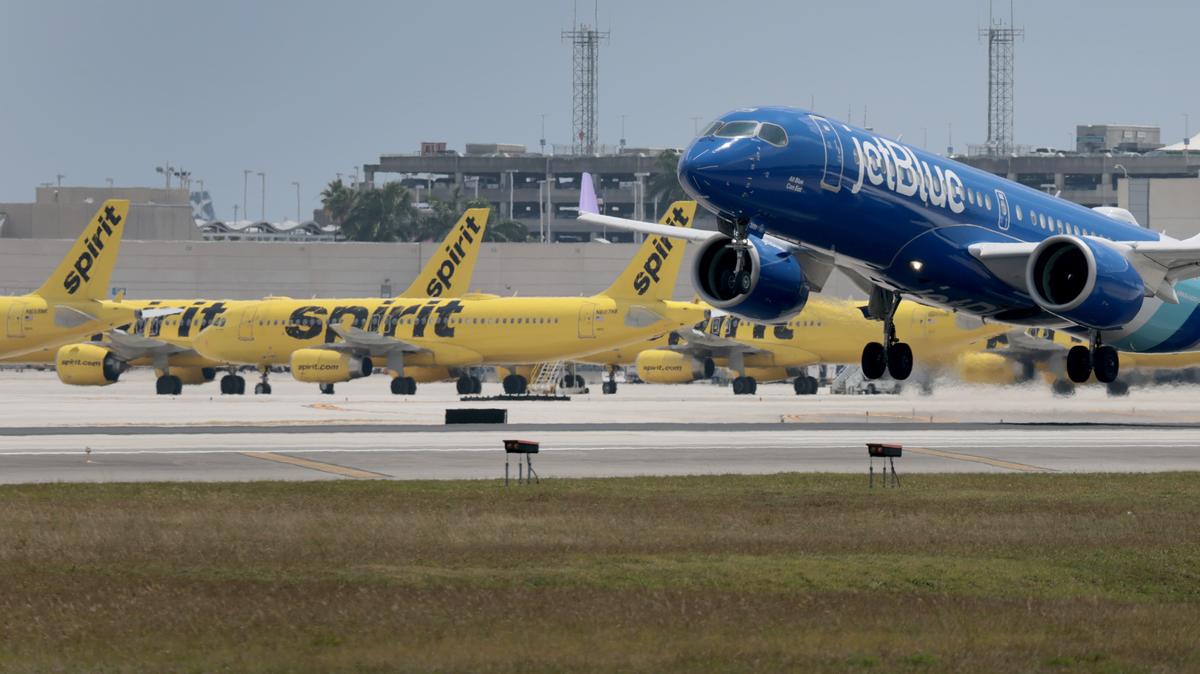 Spirit Airlines Shuts Down After Rescue Deal Talks Fall Through. FORT LAUDERDALE, FLORIDA - MAY 02: A JetBlue plane takes off near idle Spirit Airlines planes on the tarmac at the Fort Lauderdale-Hollywood International Airport on May 02, 2026 in Fort Lauderdale, Florida. Spirit Aviation Holdings Inc. announced today that it has canceled all upcoming flights and begun a wind-down of Spirit Airlines operations after failing to secure funding from the Trump administration. (Photo by Joe Raedle/Getty Images)
