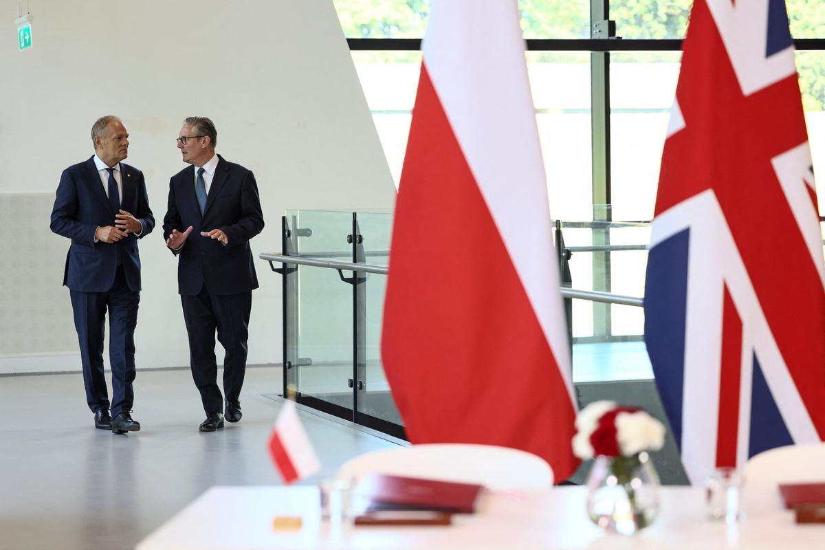 Britain's Prime Minister Keir Starmer and Polish Prime Minister Donald Tusk talk as they attend a signing ceremony of UK-Poland defence and security treaty at the Battle of Britain Bunker in Uxbridge, Britain, May 27, 2026. REUTERS/Jack Taylor/Pool