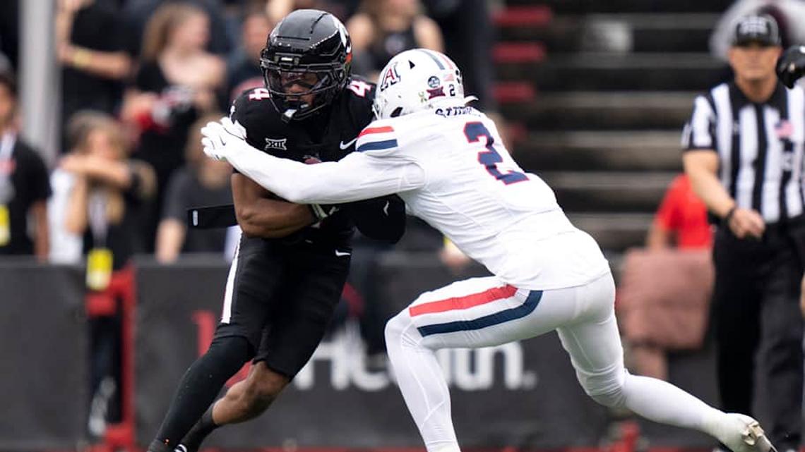  Arizona Wildcats defensive back Treydan Stukes (2) tackles Cincinnati Bearcats wide receiver Cyrus Allen (4) in the second quarter of the NCAA football at Nippert Stadium in Cincinnati on Nov. 15, 2025. | Albert Cesare/The Enquirer / USA TODAY NETWORK via Imagn Images 