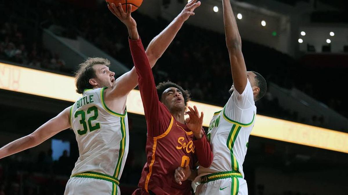  Feb 21, 2026; Los Angeles, California, USA; Southern California Trojans guard Alijah Arenas (0) shoots the ball against Oregon Ducks center Nate Bittle (32) and forward Kwame Evans Jr. (10) in the second half at Galen Center. Mandatory Credit: Kirby Lee-Imagn Images | Kirby Lee-Imagn Images 