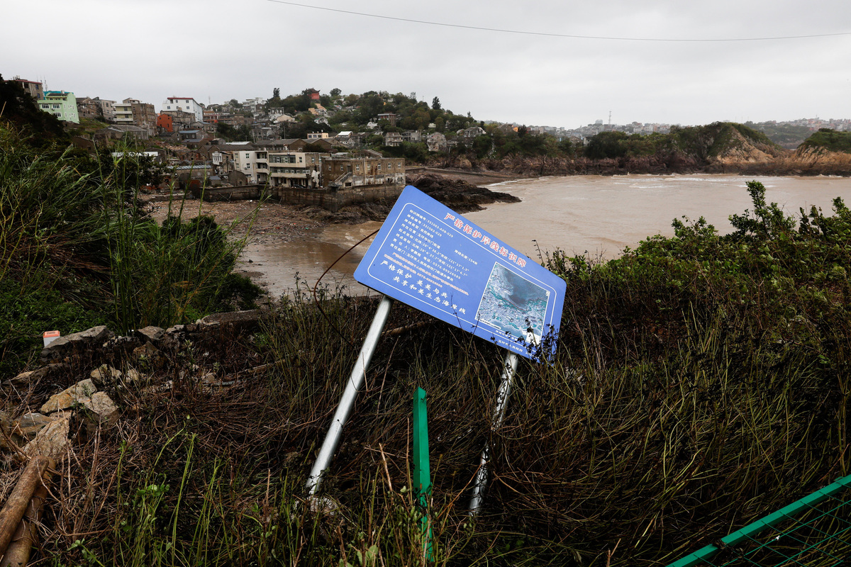 A toppled information sign in the aftermath of Typhoon Bavi in the coastal village of Dongsha, Taizhou, Zhejiang province, China, July 12, 2026. REUTERS/Go Nakamura