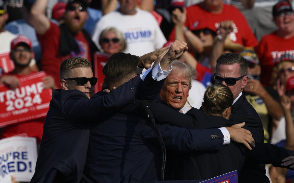  Former U.S. President Donald Trump is whisked away by Secret Service after shots rang out at a campaign rally in Butler, Pennsylvania, on July 13, 2024. The commissioner of the Pennsylvania State Police said the gunman, Thomas Matthew Crooks, had been identified as suspicious by local law enforcement before the shooting. 