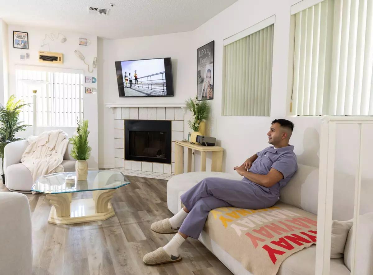The ’80s-inspired living room is filled with vintage technology, including chunky phones, old keyboards and portable TVs.