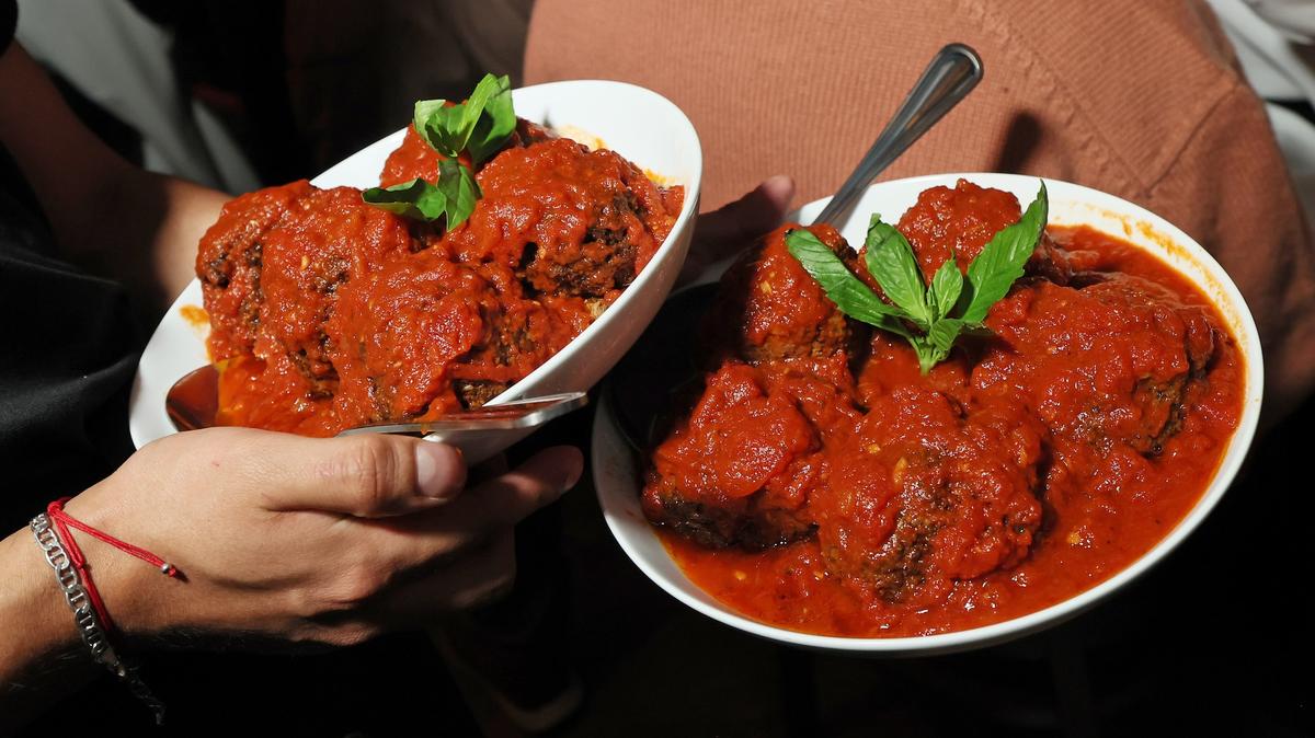 NEW YORK, NEW YORK - APRIL 23: Guests sample Rao’s Famous Meatballs and other classic plates at Dinner Rush presented by Marriott Bonvoy and American Express at JW Marriott Essex House New York on April 23, 2026 in New York City.  (Photo by Mike Coppola/Getty Images for American Express and Marriott Bonvoy)
