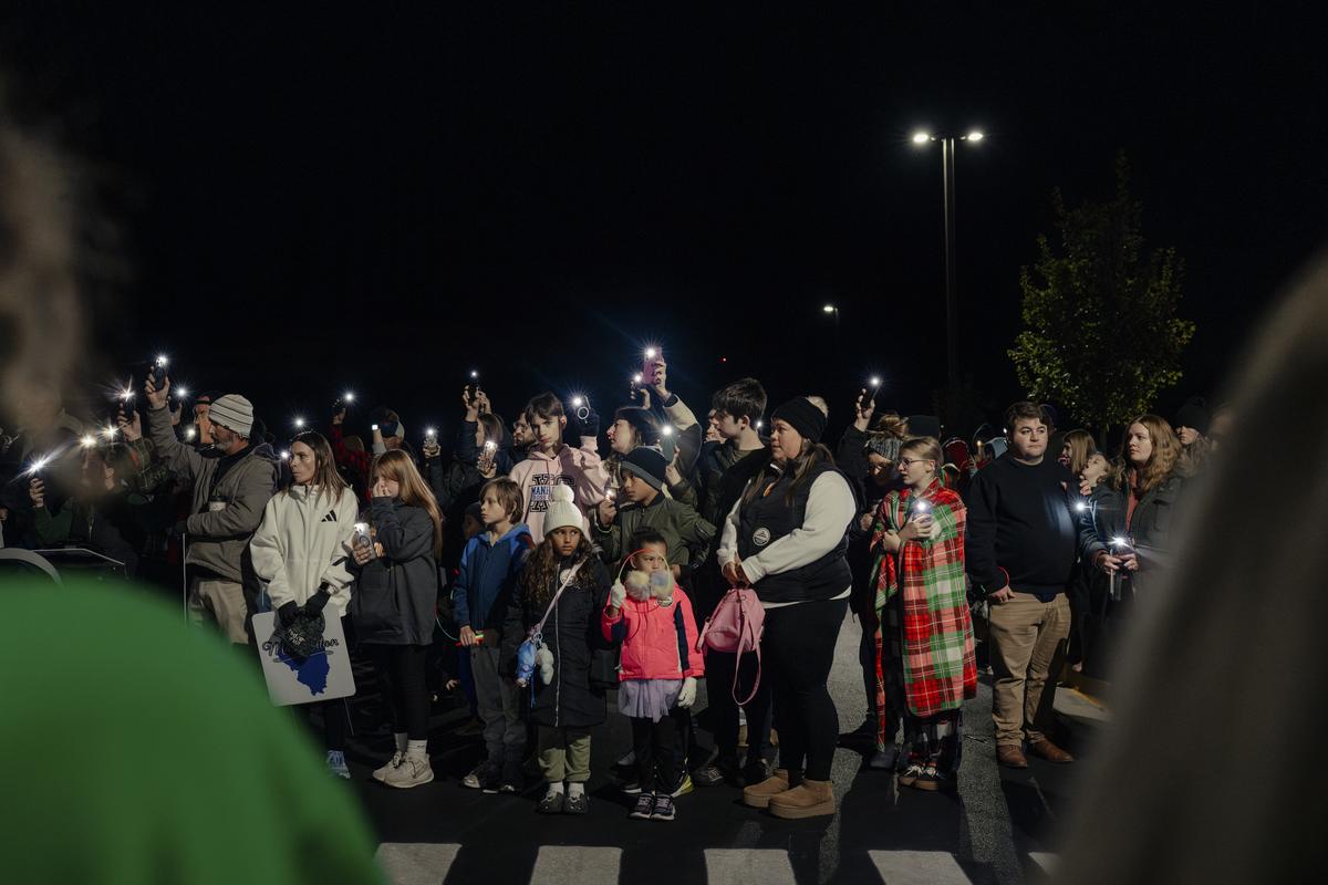 A vigil outside a junior high school in Manhattan, Ill., for youths killed by semi trucks, including 13-year-old Chance Hunnicutt, on Oct. 23, 2025. Manhattan has increased its number of officers on truck enforcement patrol over the past five years, from three to eight. But other changes are slow going. (Jamie Kelter Davis/The New York Times)....