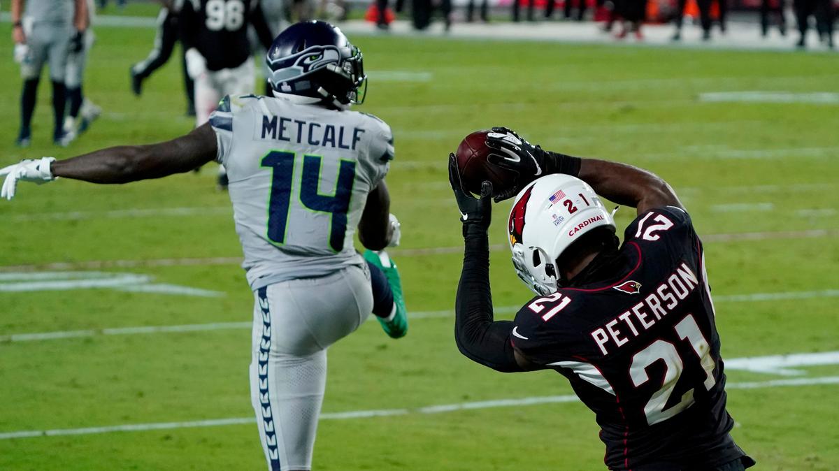 Arizona Cardinals cornerback Patrick Peterson (21) intercepts a pass intended for Seattle Seahawks wide receiver DK Metcalf (14) during the second half of an NFL football game, Sunday, Oct. 25, 2020, in Glendale, Arizona.