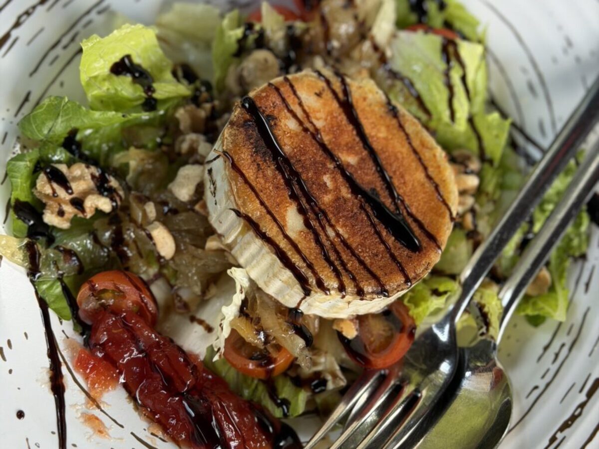  Greens, walnuts, peppers and a wheel of cheese make for a hearty salad at Asador Fiscal. Photo credit: Cathy Bennett Kopf 