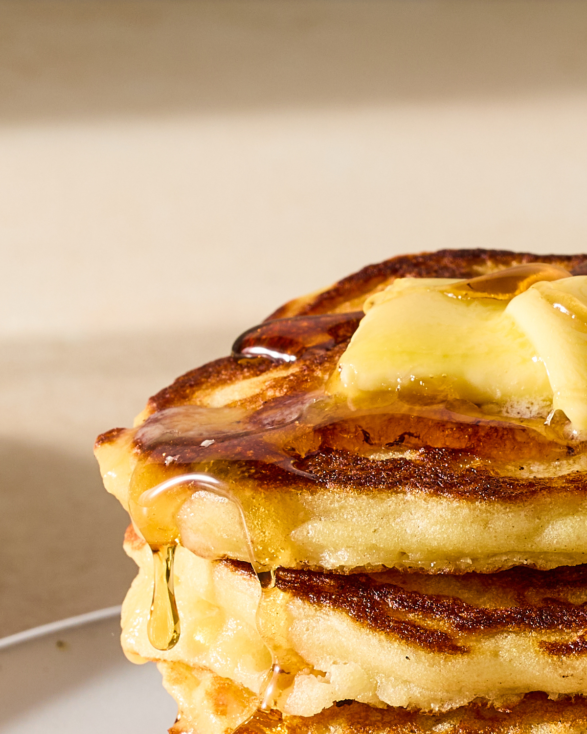 A golden stack of pancakes, slicked with butter, dripping with syrup, is one of the most rewarding breakfasts you can cook on a weekend -- a perfect way to start the day. Food Stylist: Monica Pierini. (Julia Gartland/The New York Times)