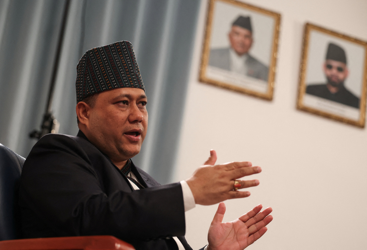 Nepal's Foreign Minister Shisir Khanal speaks in front of portraits of Nepal's President Ramchandra Paudel and Prime Minister Balendra Shah, during an interview with Reuters at the Embassy of Nepal in Beijing, China, June 16, 2026. REUTERS/Tingshu Wang