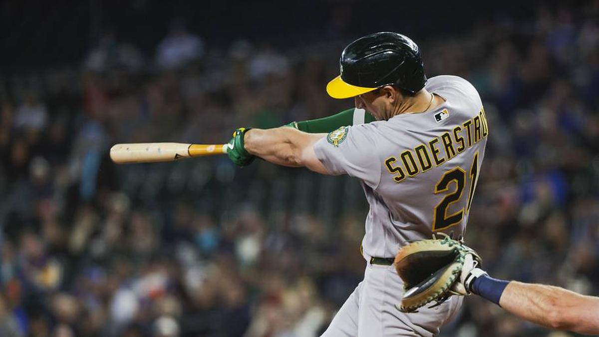  Apr 22, 2026; Seattle, Washington, USA; Athletics left fielder Tyler Soderstrom (21) hits an RBI-sacrifice fly against the Seattle Mariners during the first inning at T-Mobile Park. Mandatory Credit: Joe Nicholson-Imagn Images | Joe Nicholson-Imagn Images 