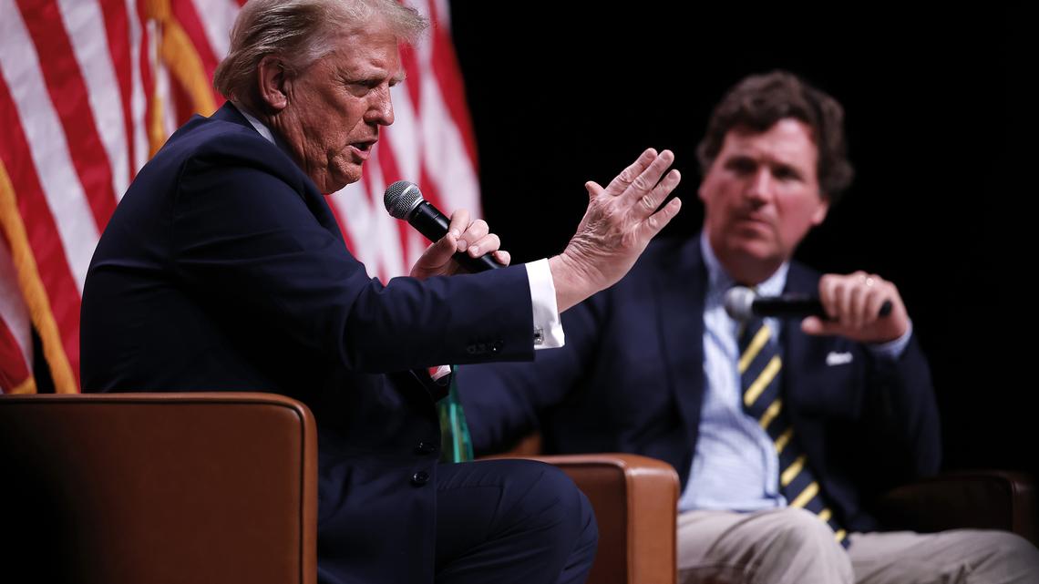 Republican presidential nominee, former President Donald Trump sits down for a conversation with Tucker Carlson during his Live Tour at the Desert Diamond Arena on Oct. 31, 2024, in Phoenix, Arizona. (Chip Somodevilla/Getty Images/TNS)