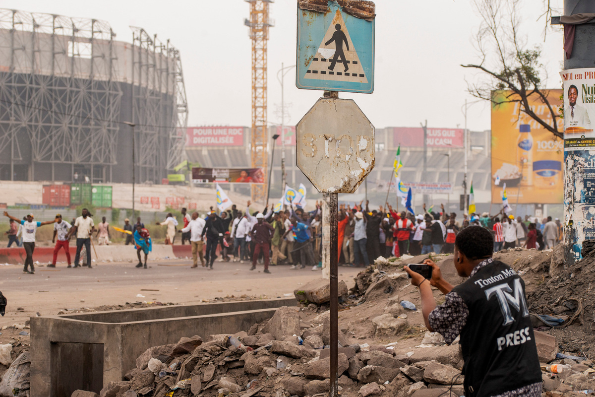 A journalist works during protests near the parliament building in Kinshasa, Democratic Republic of Congo, June 12, 2026.    REUTERS/Aristote Lokinda