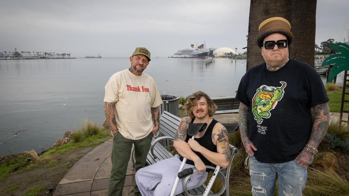 Long Beach, CA - January 22: Sublime members from left: drummer Bud Gaugh, vocalist Jakob Nowell, and guitarist Eric Wilson, in front of the Long Beach Hotel Maya in Long Beach Thursday, Jan. 22, 2026. Sublime's first album is releasing in April with original singer Brad Nowell's son, Jakob. (Allen J. Schaben / Los Angeles Times)