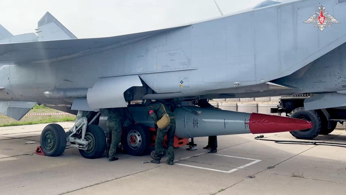 Russian service members mount a hypersonic Kinzhal missile on a MiG-31 fighter jet during a nuclear forces exercise at an unidentified location in Russia, in this still image taken from handout footage released on May 21, 2026.  Russian Defence Ministry/Handout via REUTERS