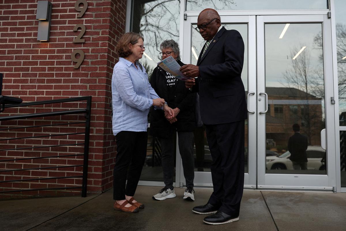 FILE PHOTO: U.S. Representative Jim Clyburn (D-SC) speaks with some before the South Carolina Democratic presidential primary in Columbia, South Carolina, U.S., January 26, 2024. REUTERS/Shannon Stapleton/File Photo