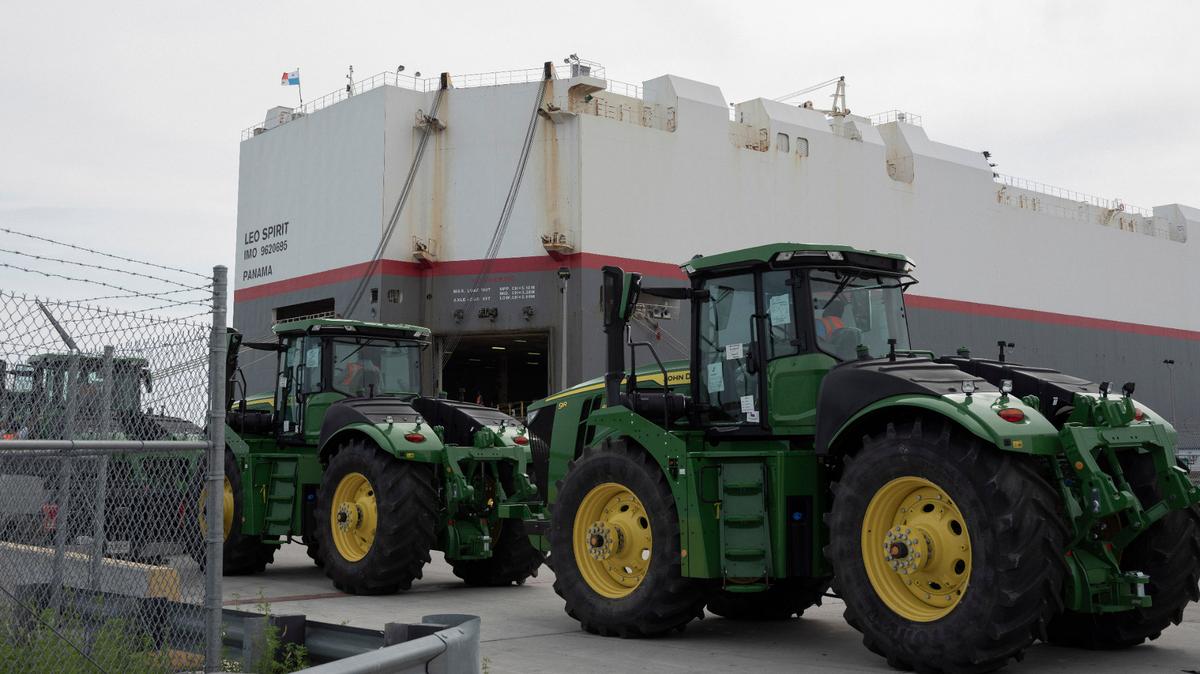 Stevedores drive John Deere tractors onto a cargo ship in the port of Brunswick, Ga., on April 10, 2024. Brunswick is one of the eastern ports absorbing cargo that, for now, cannot be handled in Baltimore in the wake of the Key Bridge collapse. A top authority there acknowledges it cannot handle all of the autos that typically move through Baltimore. (Dustin Miller/The New York Times)