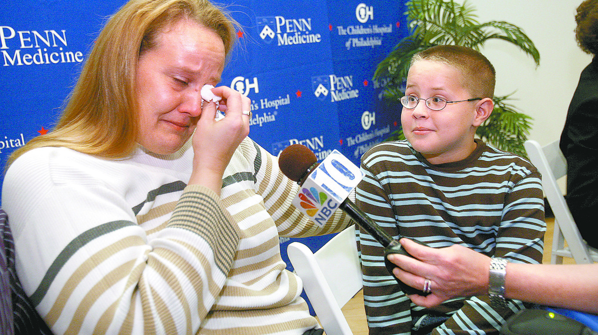 Nancy Haas of Hadley, New York, wipes away tears as she talks about the dramatic improvement in the vision of her son, Corey Haas, 9, since receiving gene therapy. Three Philadelphia scientists won a $3 million Breakthrough Prize for developing the first FDA-approved gene therapy for inherited retinal diseases, prize sponsors announced Saturday.