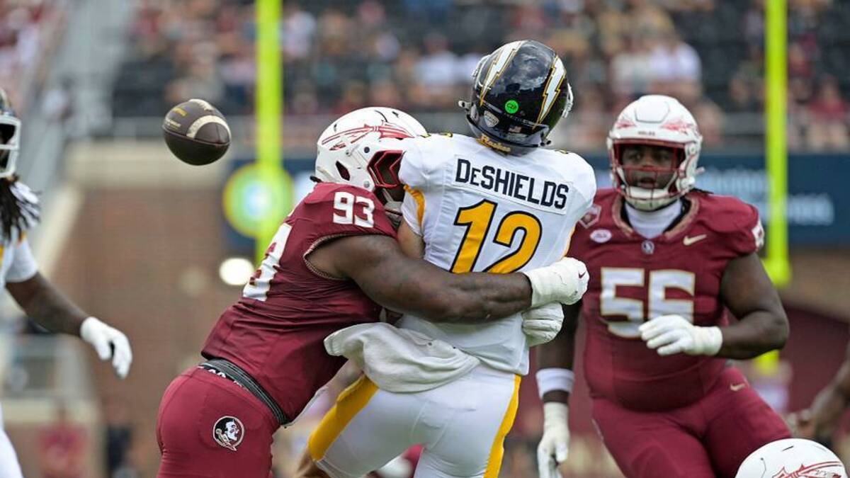  Sep 20, 2025; Tallahassee, Florida, USA; Kent State Golden Flashes quarterback Dru DeShields (12) is hit as he throws the ball by Florida State Seminoles defensive lineman Mandrell Desir (93) during the first half at Doak S. Campbell Stadium. Mandatory Credit: Melina Myers-Imagn Images | IMAGN IMAGES via Reuters Connect 