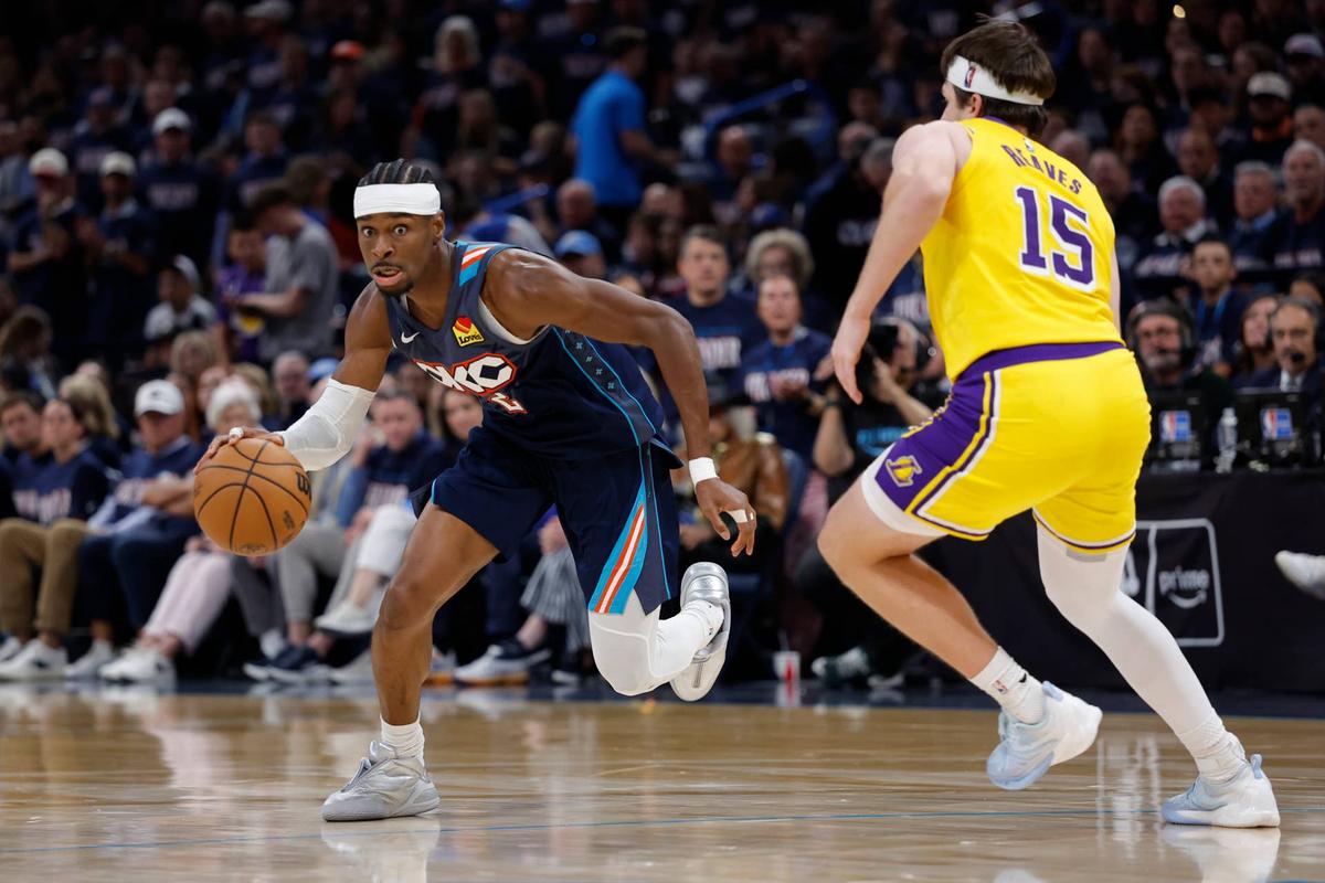  May 7, 2026; Oklahoma City, Oklahoma, USA; Oklahoma City Thunder guard Shai Gilgeous-Alexander (2) drives down the court against Los Angeles Lakers guard Austin Reaves (15) in the second half during game two of the second round of the 2026 NBA Playoffs at Paycom Center. Mandatory Credit: Alonzo Adams-Imagn Images 