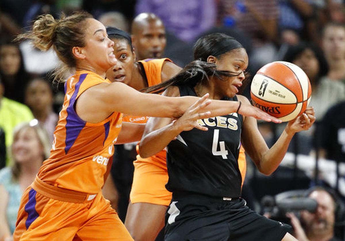 Phoenix Mercury guard Leilani Mitchell, left, knocks the ball away from Las Vegas Aces guard Moriah Jefferson during a 2018 game.