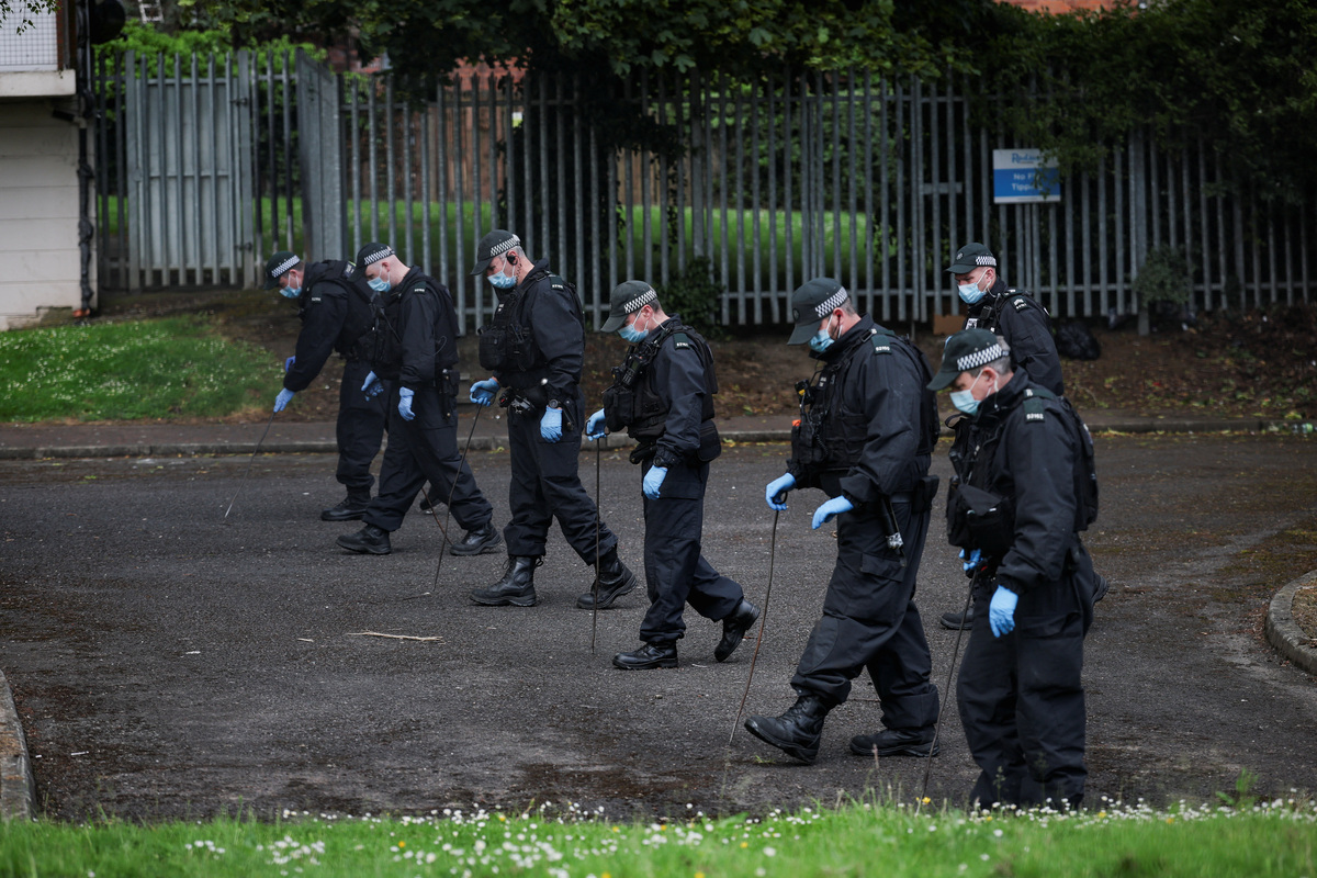 Police officers inspect the area near the scene of a stabbing outside apartments in the Kinnaird Avenue area of north Belfast, after a knife attack on June 8 left a man seriously injured and prompted police to declare a critical incident, in Belfast, Northern Ireland, June 9, 2026. REUTERS/Isabel Infantes