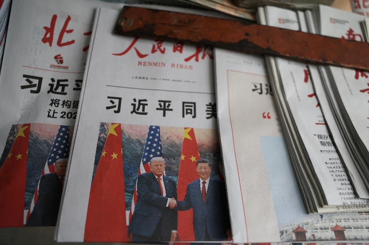 Newspapers with images of Chinese President Xi Jinping meeting U.S. President Donald Trump at the Great Hall of the People are displayed on the front page, at a newsstand in Beijing, China May 15, 2026. REUTERS/Tingshu Wang