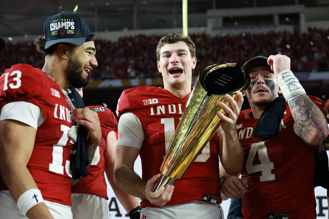  Jan 19, 2026; Miami Gardens, FL, USA; Indiana Hoosiers quarterback Fernando Mendoza (15) reacts with the trophy after the College Football Playoff National Championship game at Hard Rock Stadium. Mandatory Credit: Mark J. Rebilas-Imagn Images 
