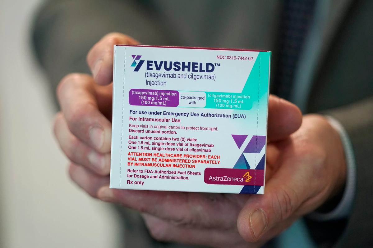 Scott Madow, a heath services manager at a University of Washington Medicine clinic, poses for a photo as he holds a box of AstraZeneca’s Evusheld, the first set of antibodies grown in a lab to prevent COVID-19, Thursday, Jan. 20, 2022, in Seattle.