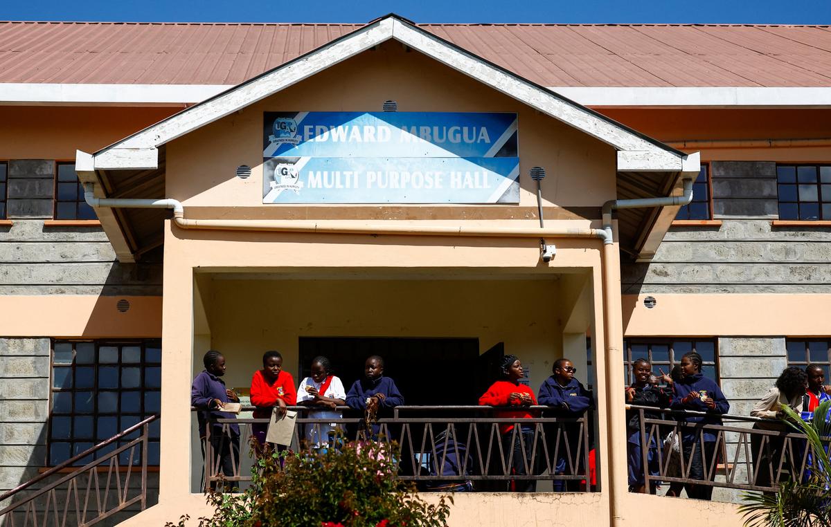 Students gather on a balcony at the Utumishi Girls' Academy Senior School following an overnight fire in a dormitory at the facility in Gilgil, Nakuru county, Kenya May 28, 2026. REUTERS/Thomas Mukoya