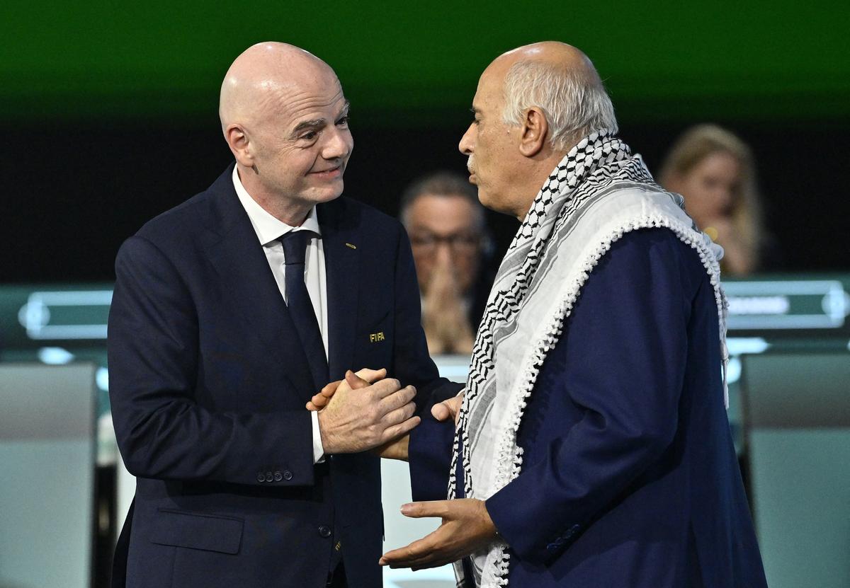 Soccer Football - 76th FIFA Congress - Vancouver Convention Centre, Vancouver, Canada - April 30, 2026  FIFA President Gianni Infantino shakes hands with Jibril Rajoub, President of the Palestine Football association during the congress REUTERS/Jennifer Gauthier