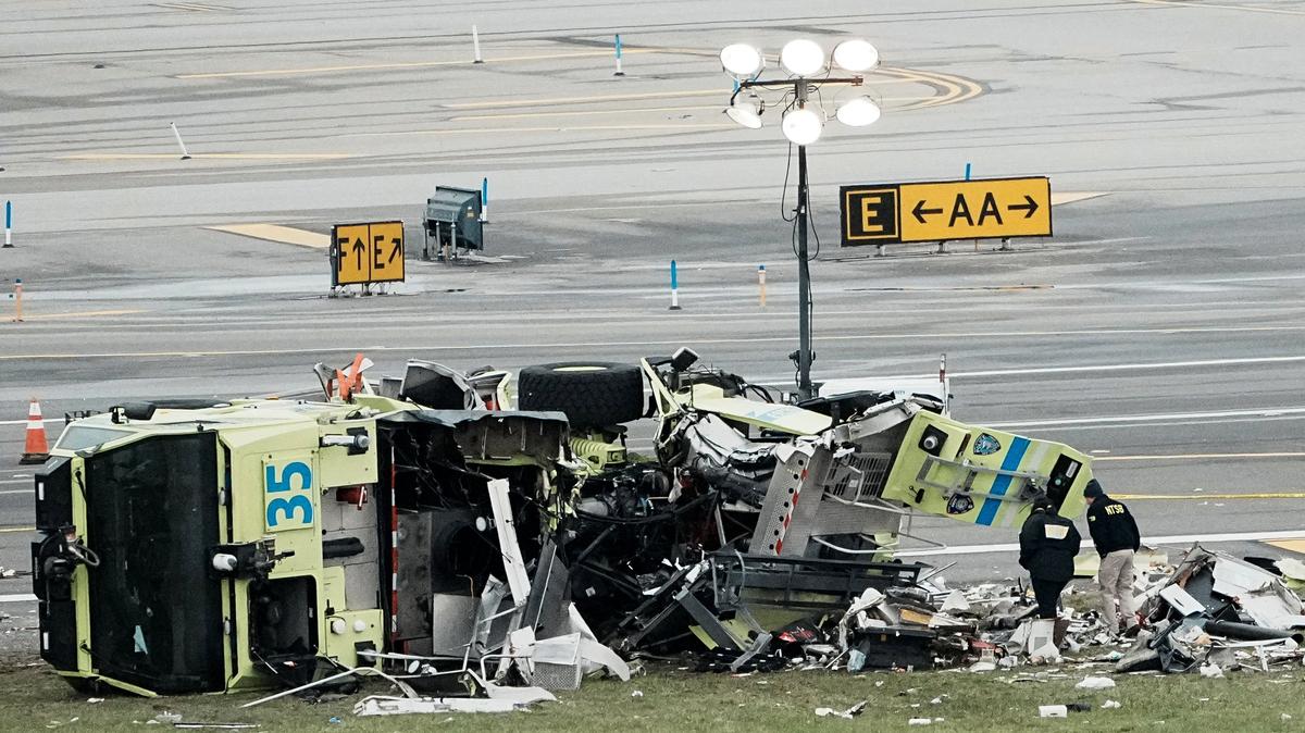 FILE PHOTO: Personnel of the National Transportation Safety Board (NTSB) inspect the wreckage of a fire truck after it collided with an Air Canada Express jet at New York's LaGuardia Airport in Queens, New York, U.S., March 23, 2026. REUTERS/Eduardo Munoz/File photo